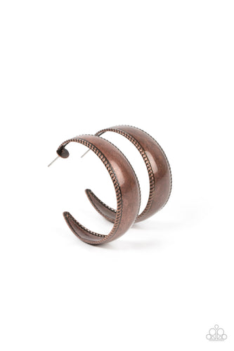 A wide smooth copper bar bordered in rope-like texture curls into a simple hoop earring, resulting in a rustic statement piece. Earring attaches to a standard post fitting. Hoop measures approximately 1 1/2