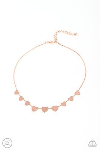 Delicately scratched in shimmer, a dainty collection of flat shiny copper heart frames gradually increases in size along a shiny copper snake chain around the neck for a flirtatious fashion. Features an adjustable clasp closure.