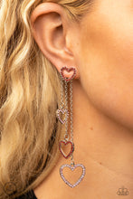 Load image into Gallery viewer, Encrusted in dainty red rhinestones, a glittery silver heart fitting attaches to a double-sided post designed to fasten behind the ear. Attached to dainty silver chains of varying lengths, a glittery collection of pink and red rhinestone dotted heart frames cascades out from behind the ear for a heart-stopping sparkle. Earring attaches to a standard post fitting.
