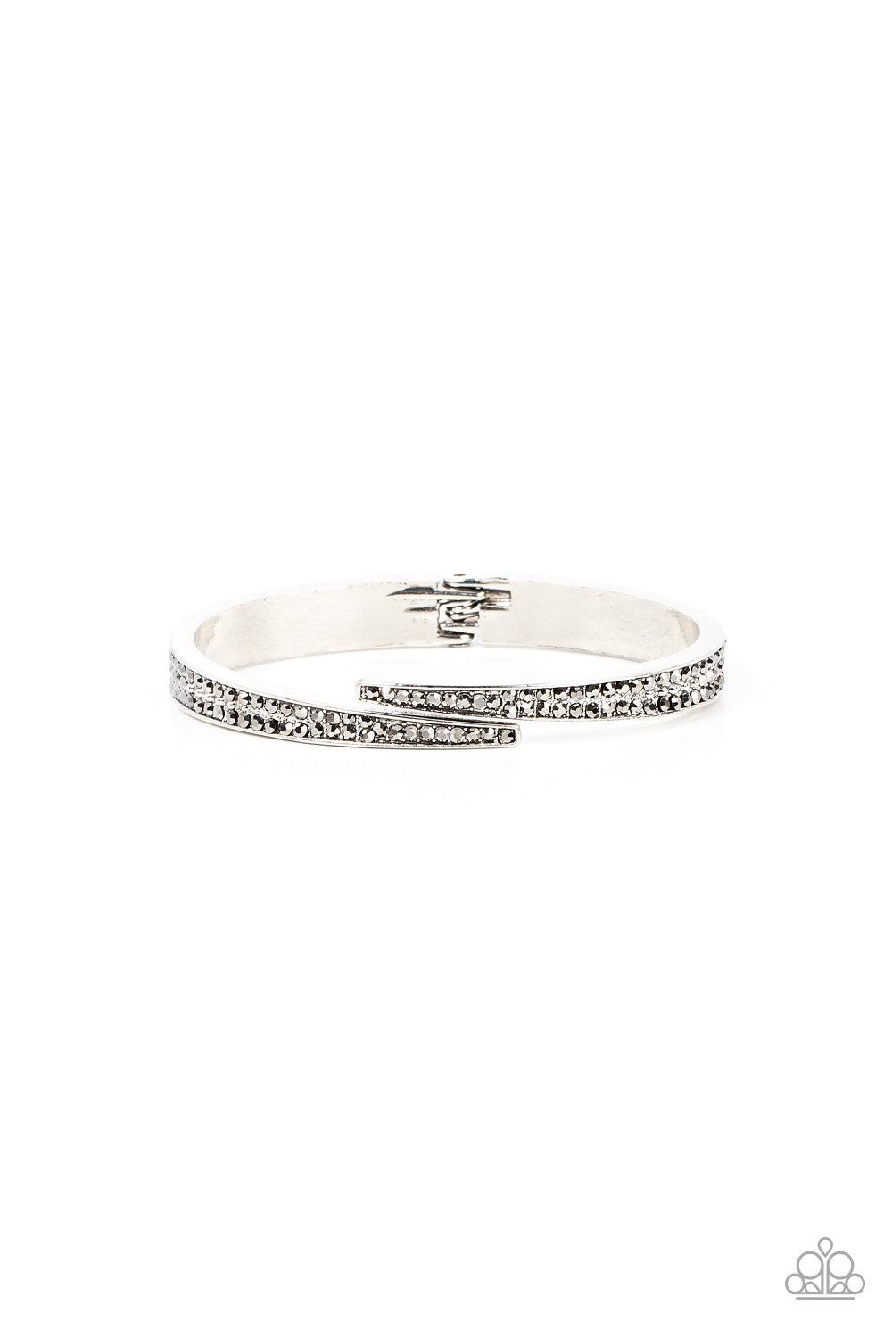 Encrusted in stacked sections of antiqued silver studs and smoky hematite rhinestones, two silver bars delicately overlap at the center of the wrist, resulting in an edgy cuff-like bangle. Features a hinged closure.