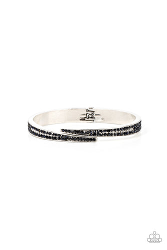 Encrusted in stacked sections of antiqued silver studs and dark blue rhinestones, two silver bars delicately overlap at the center of the wrist, resulting in an edgy cuff-like bangle. Features a hinged closure. 