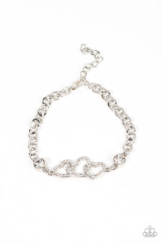 White rhinestone dotted hearts delicately interlock between two white rhinestone fittings, creating heart-pounding sparkle atop the wrist. Features an adjustable clasp closure. 