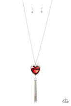 Load image into Gallery viewer, Bordered in a ribbon of glassy white rhinestones, an oversized red heart-shaped gem seemingly floats at the bottom of an extended silver chain. A shimmery silver chain tassel dances from the bottom of the sparkly pendant for a flirtatious finish. Features an adjustable clasp closure. 
