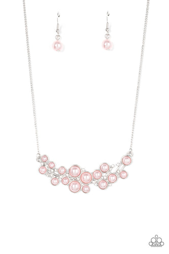 A bubbly explosion of pink pearls and glassy white rhinestones delicately coalesces into an effervescent collared pendant between two dainty silver chains. Features an adjustable clasp closure.