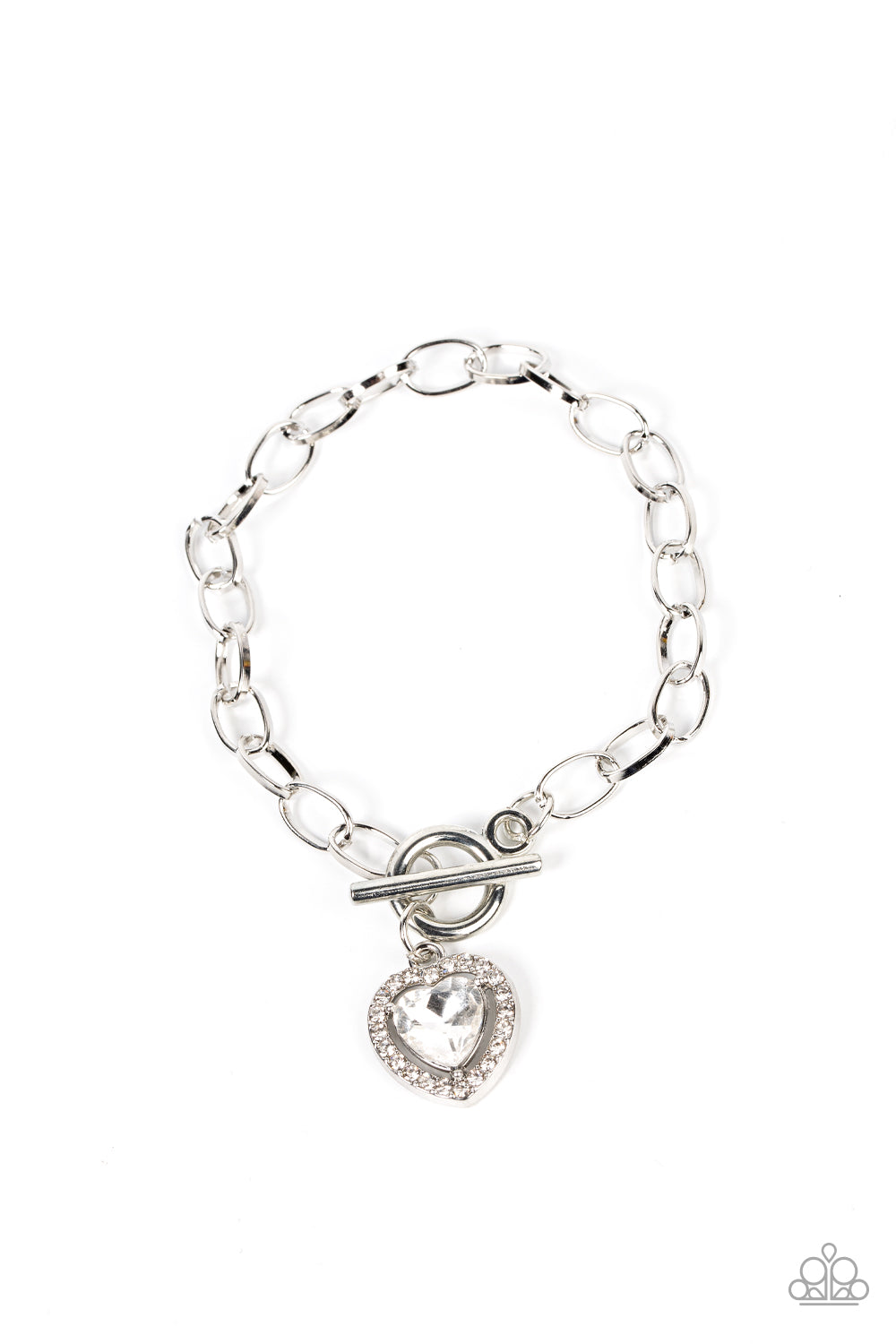 Bordered in glassy white rhinestones, a white heart shaped gem sparkles from a toggle closure at the center of an oval silver linked chain for a flirtatious fashion around the wrist. Features a toggle closure.