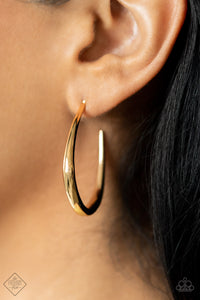 A glistening gold bar sharply curves into an asymmetrical hoop, adding a flash of high sheen luster to any outfit. Earring attaches to a standard post fitting. Hoop measures approximately 1 1/4" in diameter.  Sold as one pair of hoop earrings.  New Kit Fashion Fix