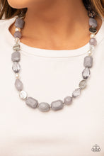 Load image into Gallery viewer, Varying in shape and opacity, a faceted collection of glassy and acrylic Ultimate Gray beads joins pearls, dainty silver beads, and zigzagged silver discs along an invisible wire across the chest for an effervescent elegance. Features an adjustable clasp closure. 
