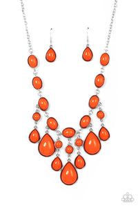 A row of burnt orange oval beads set in antiqued silver frames connect end to end across the collar. Falling from the center of the design, a trio of opulently grand teardrop beads coalesce with streams of smaller burnt orange round and teardrop beads creating a flirty fringe and dramatic allure. Features an adjustable clasp closure. 