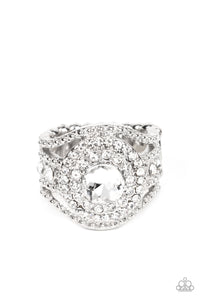 Bordered in stacked rings of glassy white rhinestones, a brilliant white gem sits atop layers of silver studded bars that swoop and stack into blinding bands across the finger. Features a stretchy band for a flexible fit.