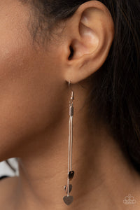 Shiny rose gold heart charms delicately trickle from varying lengths of rounded rose gold snake chains, resulting in a flirtatious tassel. Earring attaches to a standard fishhook fitting. 