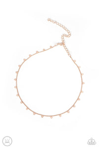 Dainty rose gold hearts dance from a dainty rose gold chain around the neck, creating a flirtatious fringe. Features an adjustable clasp closure. 