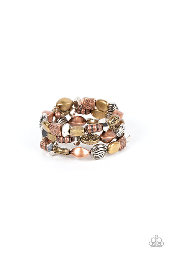 An enchanting assortment of faceted and floral embossed copper, brass, and silver beads alternates along a coiled wire, creating a whimsical infinity style bracelet around the wrist.