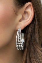 Load image into Gallery viewer, Cascading layers of sparkling white rhinestones plunge into flattened silver plates creating a stunning eye-catching hoop earring.  Earring attaches to a standard post fitting. Hoop measures approximately 2&quot; in diameter. 
