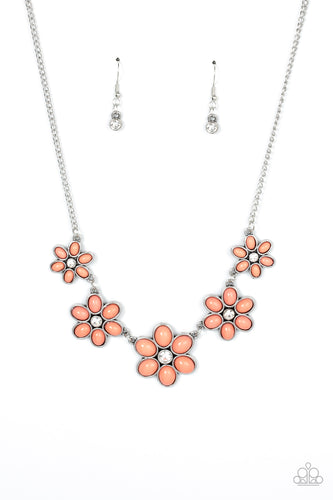 Dotted with dainty white rhinestone centers, a flirtatious assortment of coral beaded flowers gradually increase in size as they link below the collar for a playful pop of color. Features an adjustable clasp closure.
