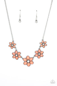 Dotted with dainty white rhinestone centers, a flirtatious assortment of coral beaded flowers gradually increase in size as they link below the collar for a playful pop of color. Features an adjustable clasp closure.