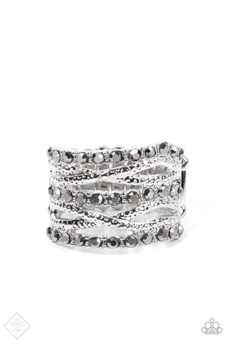Uneven rows of hematite rhinestones and hammered silver bands layer and crisscross across the finger, resulting in gritty glitz atop the finger. Features a stretchy band for a flexible fit.  Sold as one individual ring.  New Kit Fashion Fix