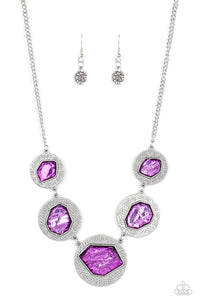 Featuring a refracted shimmer, asymmetrical, glassy purple gems sparkle atop textured silver discs as they delicately link into an edgy statement piece below the collar. Features an adjustable clasp closure. 