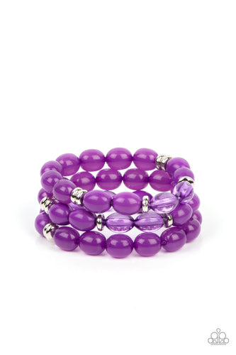 >Infused with silver accents, rows of glassy, opaque and acrylic purple beads are threaded along stretchy bands around the wrist, resulting in vivacious layers.