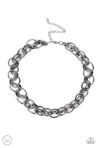 An oversized gunmetal chain interlocks with an oval linked chain, resulting in a rebellious fashion around the neck. Features an adjustable clasp closure.