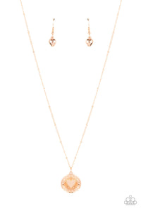 Embossed with a dainty heart, a gold pendant bursts from the center of a dainty gold satellite chain below the collar for a romantic flair. Features an adjustable clasp closure.