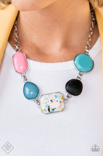 Featuring vivacious pops of color and mismatched sized frames, a boisterous collection of solid and milky beads, black wood, and a flecked terrazzo stone, are encased in simple silver frames. Attached to a silver chain link style chain, the adventurous assortment creates a funky outside-the-box fashion as it connects below the collar. Features an adjustable clasp closure.  Sold as one individual necklace. Includes one pair of matching earrings.  New Kit Fashion Fix