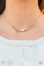 Load image into Gallery viewer, A trio of earthy white stone discs is flanked by square gold beads threaded along a dainty gold chain, creating a harmonious display. Features an adjustable clasp closure. 
