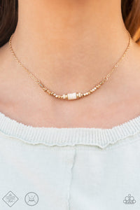 A trio of earthy white stone discs is flanked by square gold beads threaded along a dainty gold chain, creating a harmonious display. Features an adjustable clasp closure. 