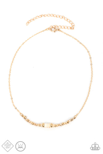 A trio of earthy white stone discs is flanked by square gold beads threaded along a dainty gold chain, creating a harmonious display. Features an adjustable clasp closure. 