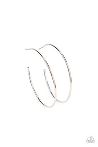 A glistening silver wire boldly curls into an oversized hoop, creating a minimalist inspired fashion. Earring attaches to a post fitting. Hoop measures approximately 2" in diameter. 