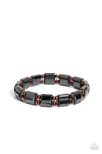 Pairs of metal discs coated in an oil fill finish, stack between metallic, square-like beads in a sleek gunmetal finish. The elements are threaded along stretchy bands, wrapping comfortably around the wrist. 