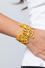 Load image into Gallery viewer, Featuring an airy stenciled pattern, yellow leather butterflies flutter across the wrist as they delicately connect into a colorful centerpiece. Features an adjustable snap closure.
