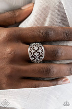 Load image into Gallery viewer, A wide, high sheen silver frame, infused with fanciful floral filigree, creates a romantically idyllic centerpiece atop the finger. Features a stretchy band for a flexible fit.  Sold as one individual ring.  New Kit Fashion Fix
