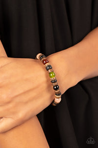 Glassy multicolored stone beads join trios of black and brown wooden discs along stretchy bands around the wrist, resulting in an earthy pop of color.