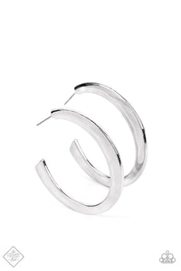 A thick, flat silver bar curls dramatically into a bold hoop. The surface of the hoop is hammered in subtle texture, adding a touch of handcrafted detail to the simple design. Earring attaches to a standard post fitting. Hoop measures approximately 1 3/4"" in diameter.  Sold as one pair of hoop earri
