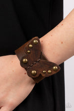 Load image into Gallery viewer, Dotted with antiqued brass studs, a distressed leather butterfly is studded in place across the center of a distressed brown leather band for a rustic flair. Features an adjustable snap closure.
