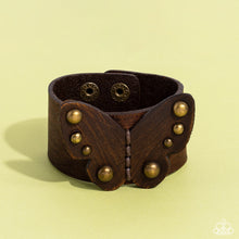 Load image into Gallery viewer, Dotted with antiqued brass studs, a distressed leather butterfly is studded in place across the center of a distressed brown leather band for a rustic flair. Features an adjustable snap closure.
