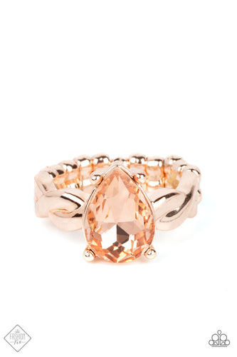 A luxurious peach teardrop gem sits regally atop a twisted rose gold band, creating a stunning centerpiece atop the finger. Features a dainty stretchy band for a flexible fit.  Sold as one individual ring.  New Kit Fashion Fix