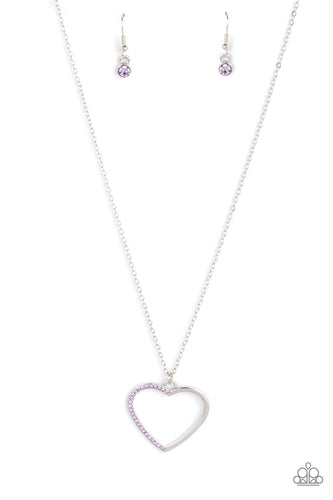 One side of a shiny silver heart frame has been adorned in dainty purple rhinestones, resulting in a flirtatious pendant at the bottom of a dainty silver chain. Features an adjustable clasp closure.