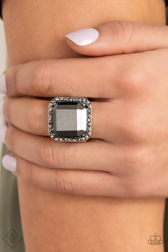 A lavish square hematite gem, encased in a border of dainty hematite rhinestones, makes a head-turning centerpiece as it gleams with an industrial edge atop the finger. Features a stretchy band for a flexible fit.  Sold as one individual ring.  New Kit Fashion Fix