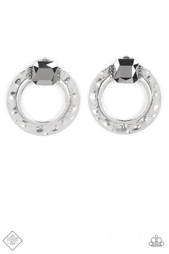 A generous square-cut hematite gem, flanked by dainty hematite rhinestones, is perched at the top of a hammered circle of antiqued silver. The faceted gem gives off a scintillating shimmer above the airy circle, making an eye-catching lure. Earring attaches to a standard post fitting.  Sold as one pair of post earrings.  New Kit Clip On Earring Fashion Fix
