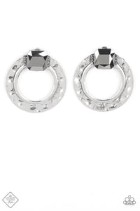 A generous square-cut hematite gem, flanked by dainty hematite rhinestones, is perched at the top of a hammered circle of antiqued silver. The faceted gem gives off a scintillating shimmer above the airy circle, making an eye-catching lure. Earring attaches to a standard post fitting.  Sold as one pair of post earrings.  New Kit Clip On Earring Fashion Fix