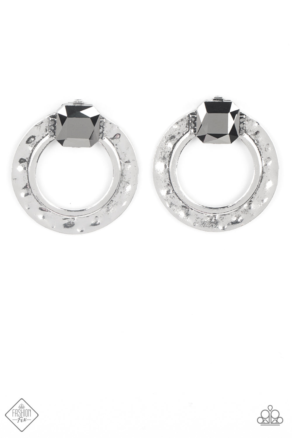 A generous square-cut hematite gem, flanked by dainty hematite rhinestones, is perched at the top of a hammered circle of antiqued silver. The faceted gem gives off a scintillating shimmer above the airy circle, making an eye-catching lure. Earring attaches to a standard post fitting.  Sold as one pair of post earrings.  New Kit Clip On Earring Fashion Fix