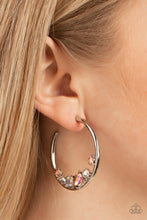 Load image into Gallery viewer, Featuring various cuts and shimmer, mismatched white, iridescent and UV peach rhinestones delicately collect along the bottom of a classic silver hoop for a glitzy accent. Earring attaches to a standard post fitting. Hoop measures approximately 1 3/4&quot; in diameter. 
