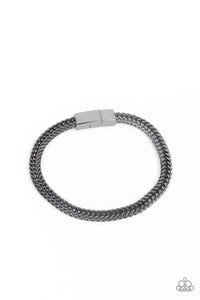 Rows of angular gunmetal links stack and interlock into a bold 3-dimensional chain around the wrist, resulting in an intense statement piece. Features a magnetic closure.
