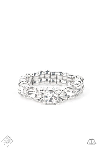 A gorgeous white rhinestone solitaire is bordered by marquise cut rhinestones tipped onto their sides followed by dainty rhinestones that add an endearing touch to the sentimental band. Features a dainty stretchy band for a flexible fit.  Sold as one individual ring.  New Kit Fashion Fix