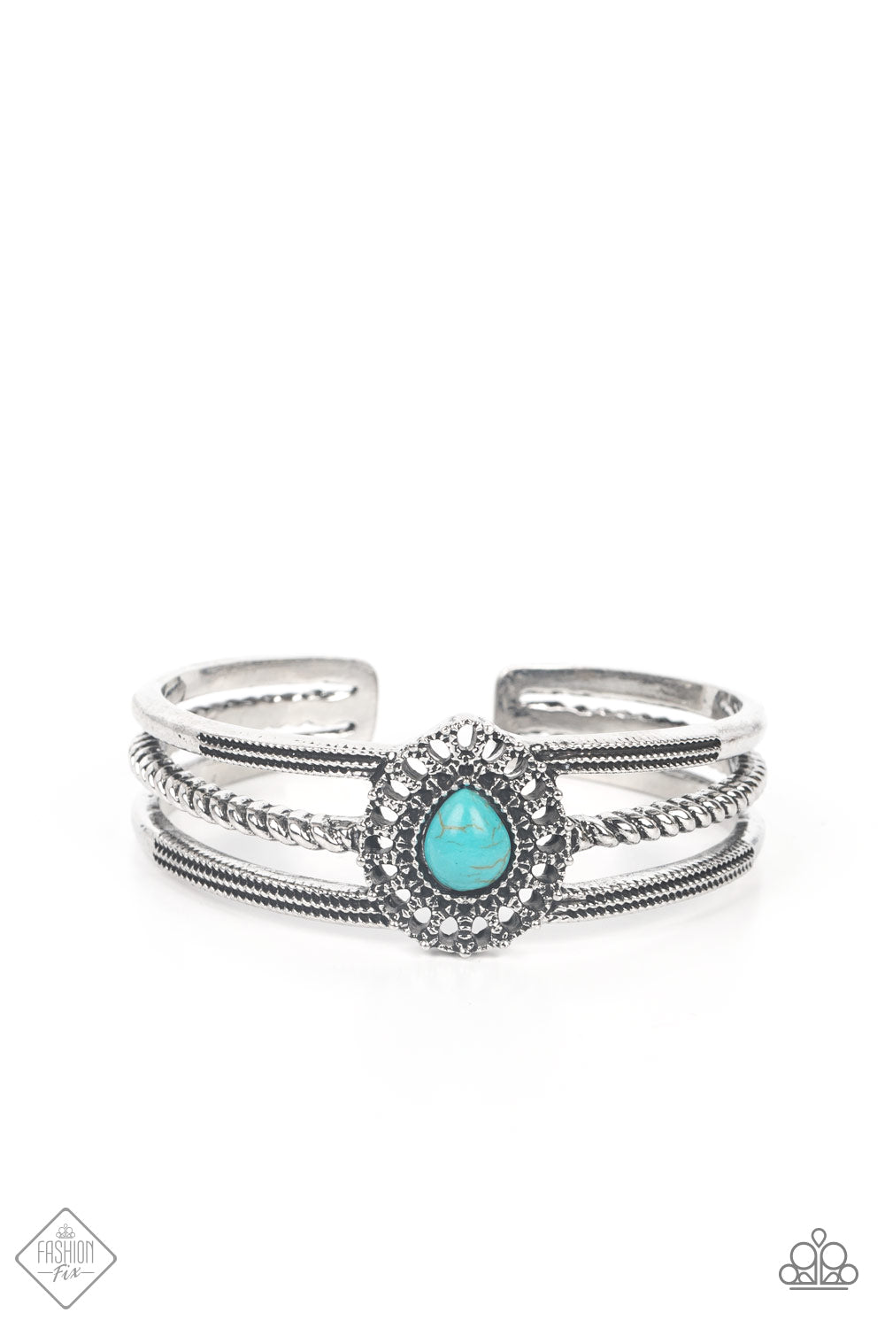A turquoise teardrop stone, encased in an embellished studded frame, sits prominently at the center of three silver bands. Wrapped in ropelike and studded texture, the rustic bands coalesce into an airy cuff bracelet.  Sold as one individual bracelet.  New Kit Fashion Fix