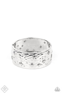 A wide silver band, hammered with subtle texture, is sprinkled with a constellation of embossed silver stars and sparkling dainty white rhinestones, creating a heavenly display around the wrist. Features a hinged closure.  Sold as one individual bracelet.  New Kit Fashion Fix