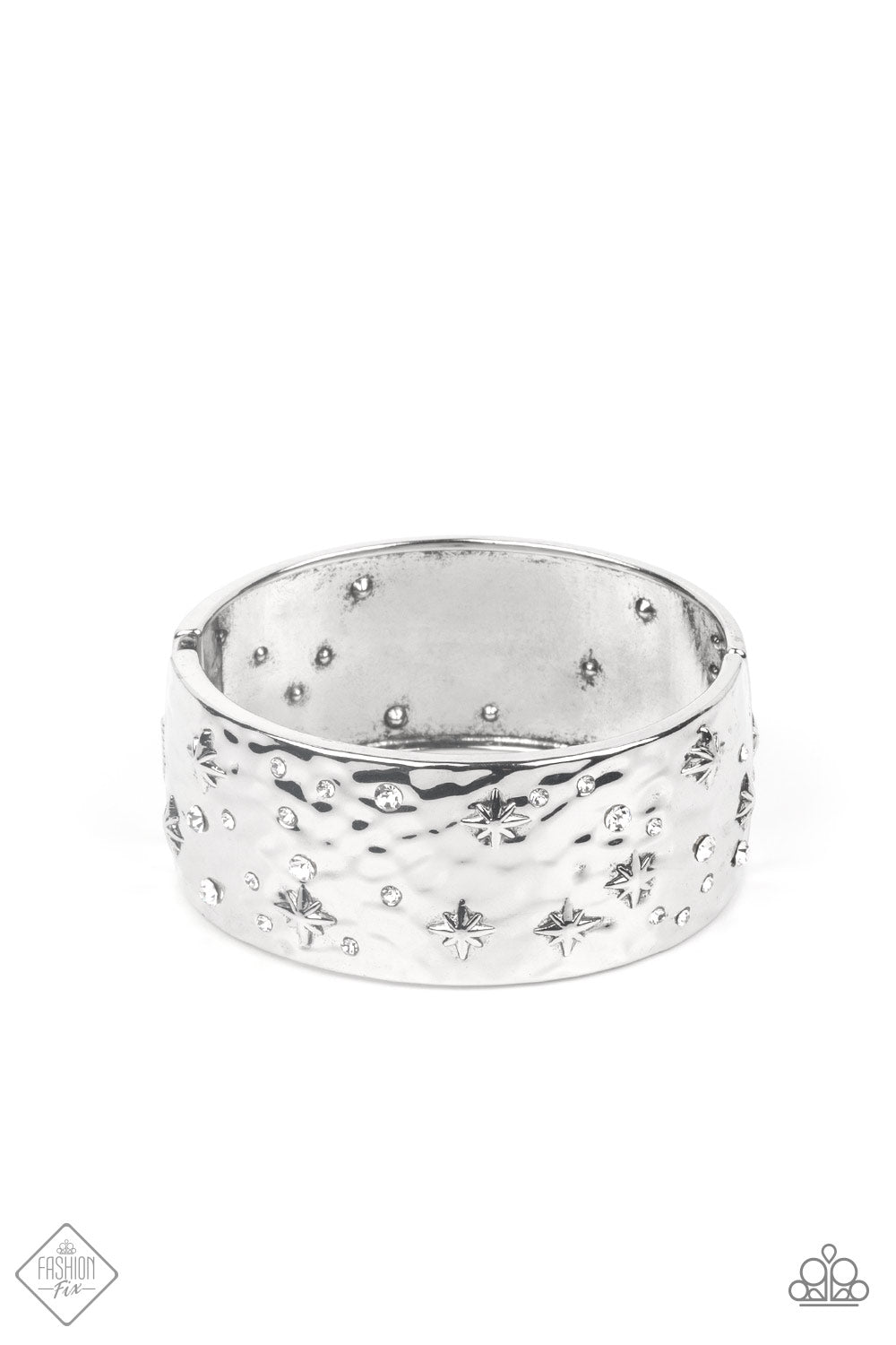 A wide silver band, hammered with subtle texture, is sprinkled with a constellation of embossed silver stars and sparkling dainty white rhinestones, creating a heavenly display around the wrist. Features a hinged closure.  Sold as one individual bracelet.  New Kit Fashion Fix
