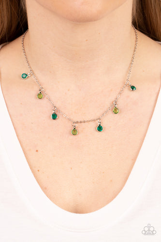 Encased in sleek silver fittings, a dainty collection of glassy green and light green gems twinkles along a dainty silver chain below the collar, creating a colorful fringe. Features an adjustable clasp closure.