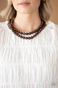 Faceted Coca Mocha and golden acrylic beads are threaded along invisible wires below the collar, creating a modern pop of color.